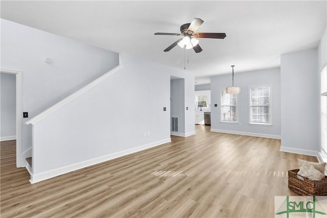 unfurnished living room with ceiling fan and light wood-type flooring