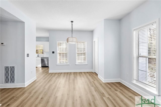 unfurnished dining area with light hardwood / wood-style flooring