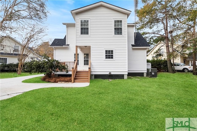 rear view of house featuring a lawn