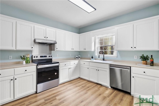 kitchen featuring white cabinetry, sink, stainless steel appliances, and light hardwood / wood-style floors