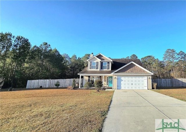 view of front of property featuring a garage and a front lawn