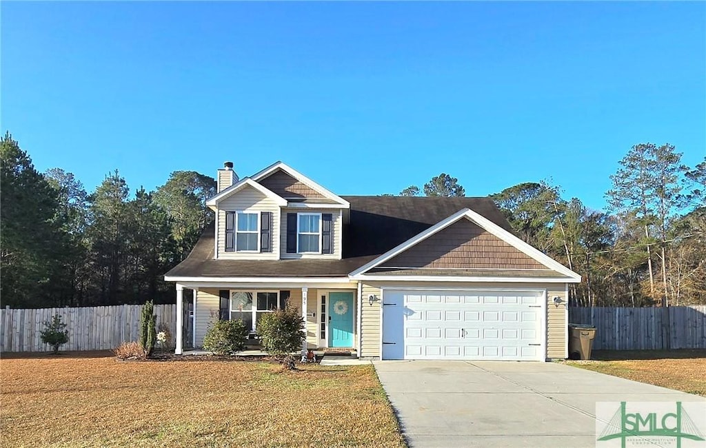 view of front of property featuring an attached garage, fence, a front lawn, and concrete driveway