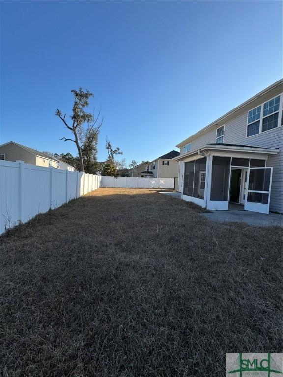 709 Eden Ln, Hinesville, GA 31313 - view of yard with a fenced backyard and a sunroom