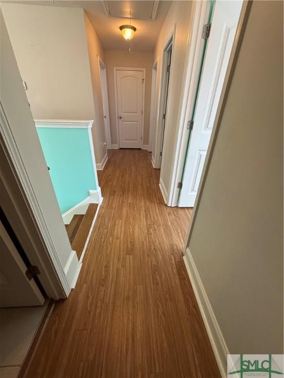 709 Eden Ln, Hinesville, GA 31313 - corridor featuring attic access, baseboards, and wood finished floors