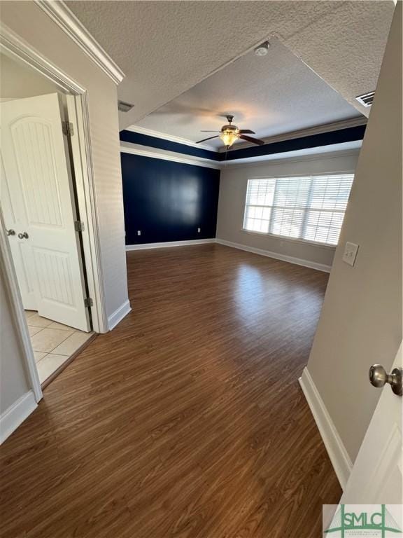 709 Eden Ln, Hinesville, GA 31313 - interior space with a tray ceiling, crown molding, a ceiling fan, a textured ceiling, and wood finished floors