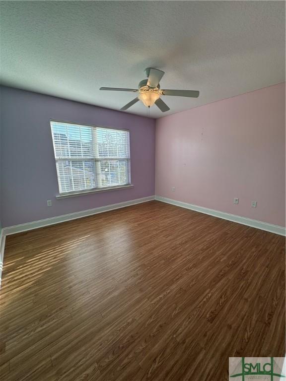 709 Eden Ln, Hinesville, GA 31313 - spare room featuring dark wood-style floors and baseboards