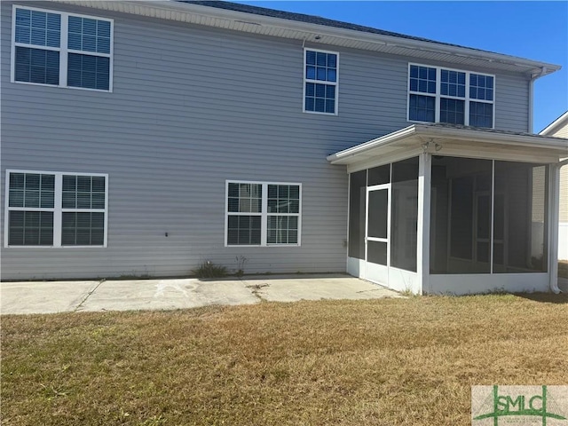 709 Eden Ln, Hinesville, GA 31313 - rear view of house featuring a yard, a patio area, and a sunroom
