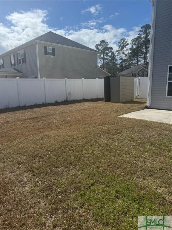 709 Eden Ln, Hinesville, GA 31313 - view of yard featuring a patio area, a shed, an outdoor structure, and a fenced backyard