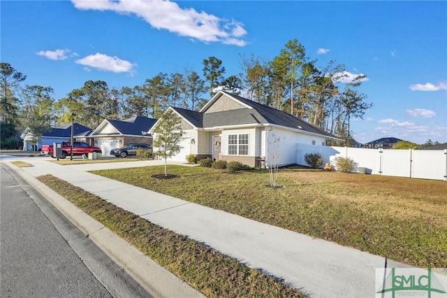 single story home featuring a garage and a front lawn