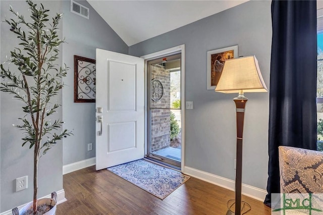 entryway featuring dark wood-type flooring and lofted ceiling