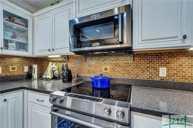 kitchen with white cabinetry, appliances with stainless steel finishes, and tasteful backsplash