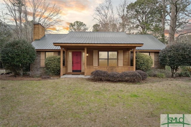 view of front of house featuring a yard and covered porch