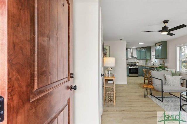 interior space with light hardwood / wood-style floors and ceiling fan