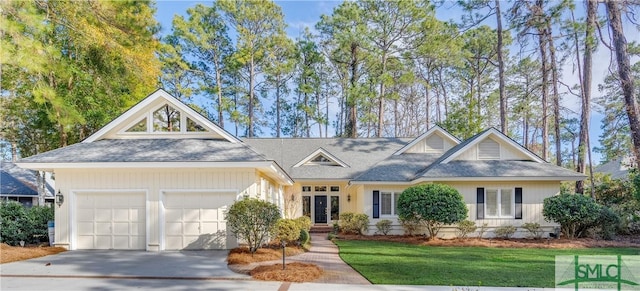 view of front of house featuring a garage and a front lawn