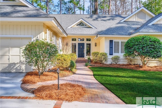 view of front of property featuring a garage and a front lawn