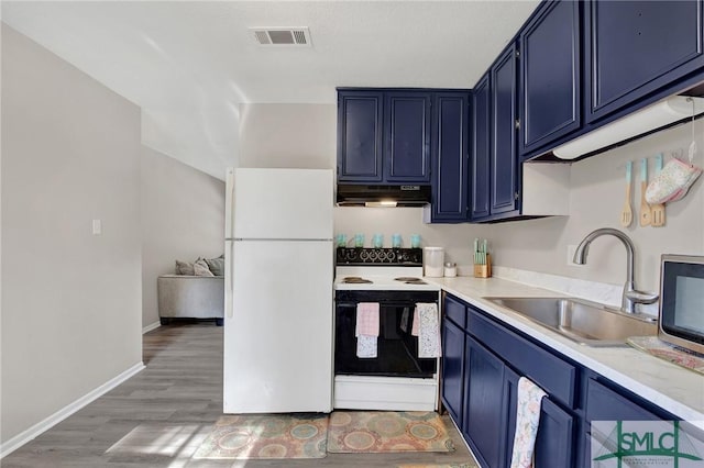 kitchen featuring blue cabinets, wood-type flooring, sink, and white appliances