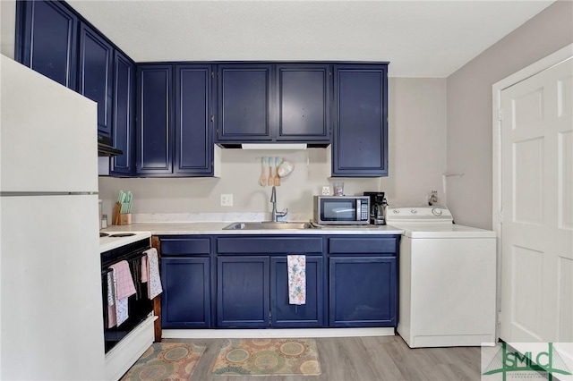 kitchen with sink, white appliances, light hardwood / wood-style flooring, blue cabinets, and washer / clothes dryer