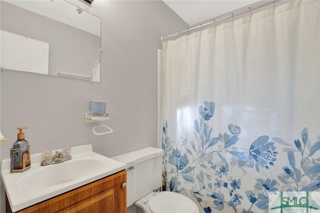 bathroom with vanity, toilet, and walk in shower