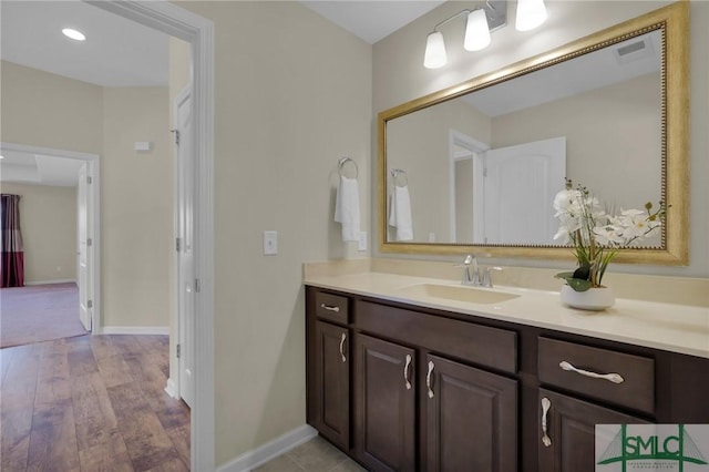 bathroom with vanity and wood-type flooring