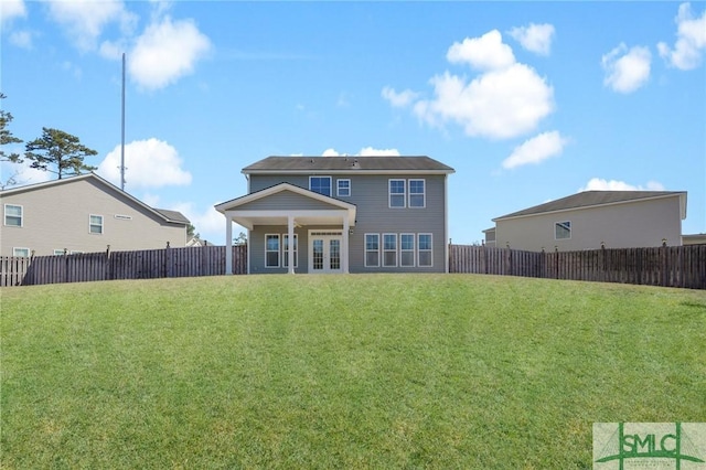 rear view of property featuring french doors and a lawn