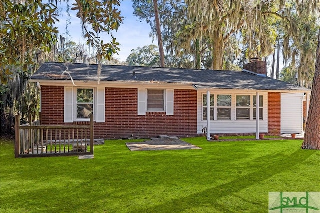 rear view of house featuring a lawn