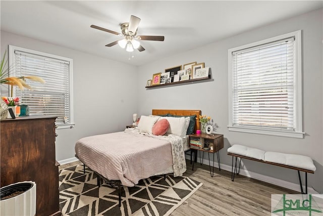 bedroom with ceiling fan and light wood-type flooring