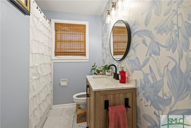 bathroom featuring vanity, tile patterned floors, and toilet