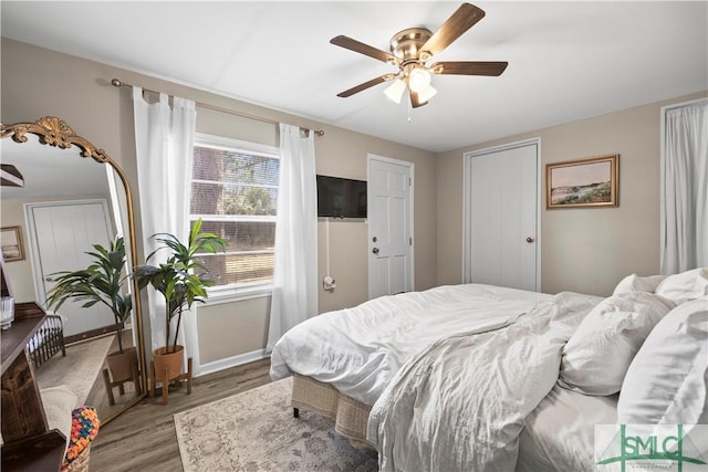 bedroom featuring hardwood / wood-style flooring and ceiling fan