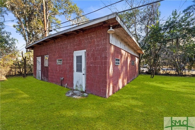 view of outdoor structure featuring a lawn