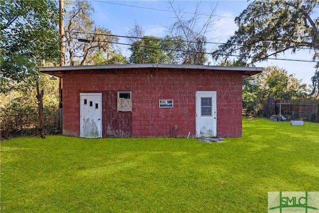 view of outbuilding with a lawn