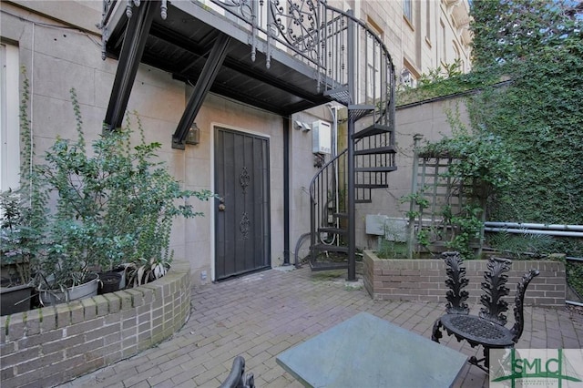 entrance to property featuring a patio