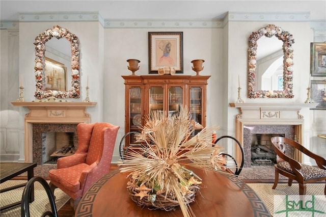 sitting room with crown molding and a fireplace