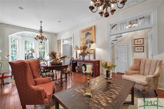 living area featuring hardwood / wood-style flooring and a chandelier