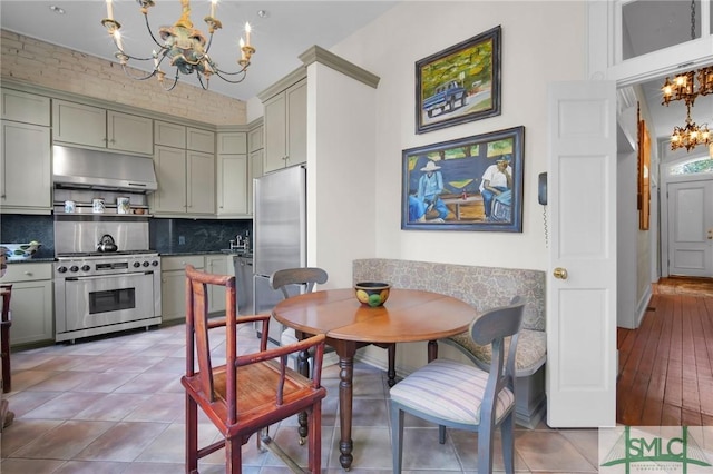 tiled dining room with an inviting chandelier