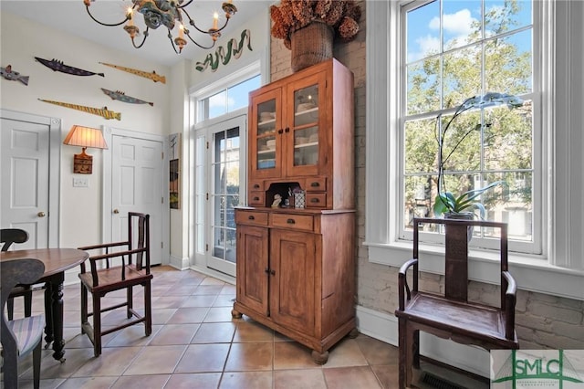 dining area with an inviting chandelier and light tile patterned floors