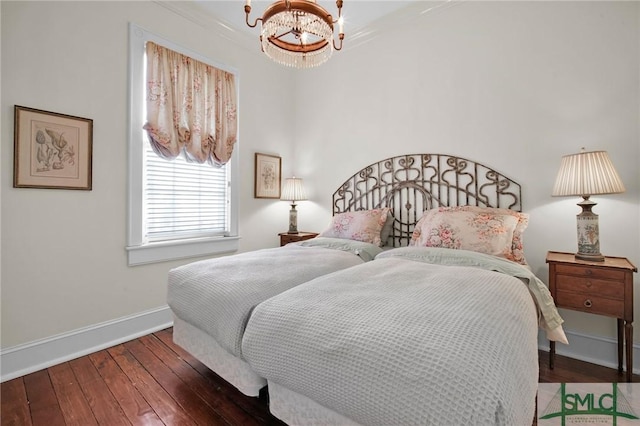 bedroom with an inviting chandelier and dark wood-type flooring