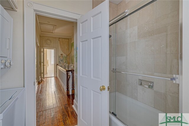 bathroom with enclosed tub / shower combo and hardwood / wood-style floors