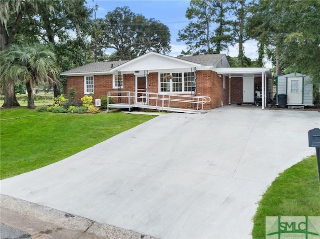 ranch-style home featuring a carport, a front yard, and a storage shed