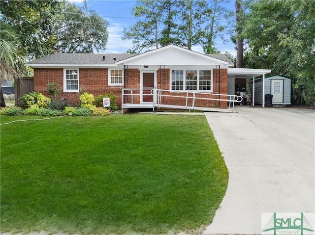 view of front of property featuring a carport, a storage unit, and a front yard