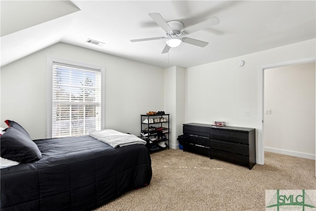 bedroom with ceiling fan, vaulted ceiling, and light carpet