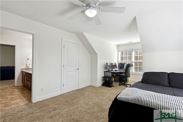 carpeted bedroom with lofted ceiling and ensuite bath