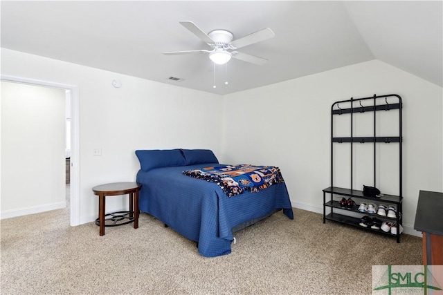 bedroom with ceiling fan, lofted ceiling, and carpet flooring