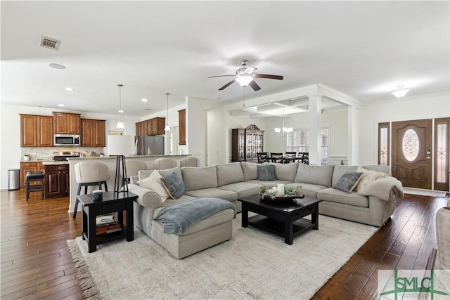 living room featuring ceiling fan with notable chandelier and light hardwood / wood-style floors