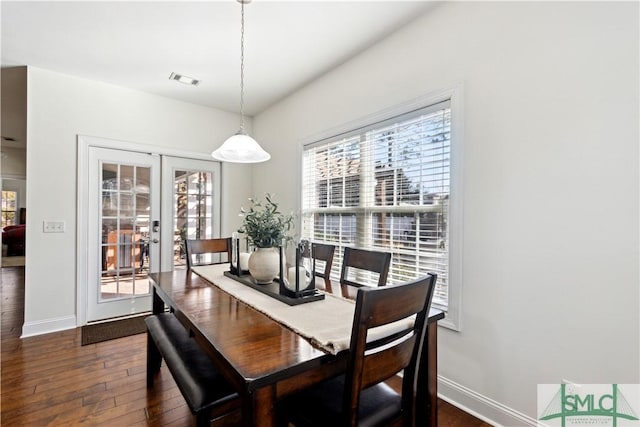 dining area with dark hardwood / wood-style flooring and french doors