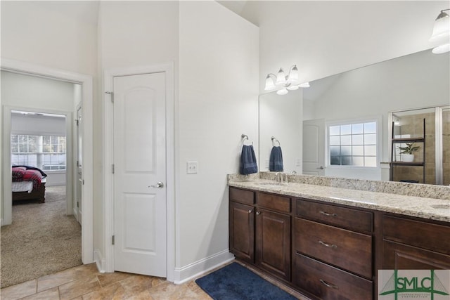 bathroom with lofted ceiling, vanity, and a shower