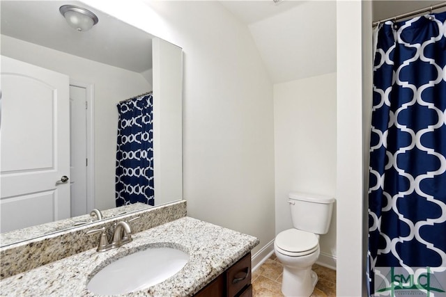 bathroom with vaulted ceiling, vanity, toilet, and tile patterned flooring