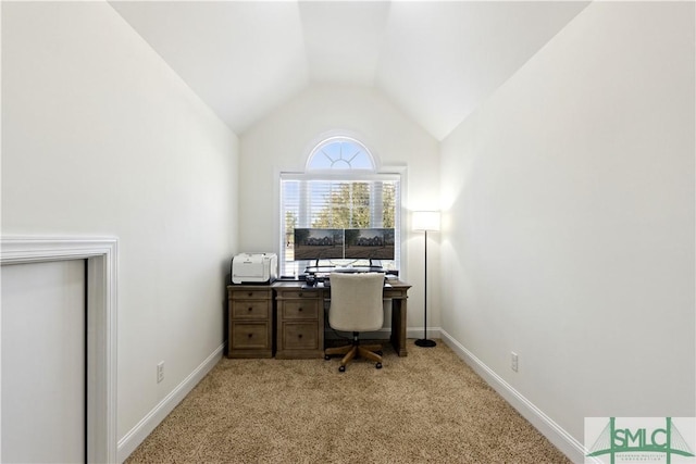 carpeted office space featuring vaulted ceiling