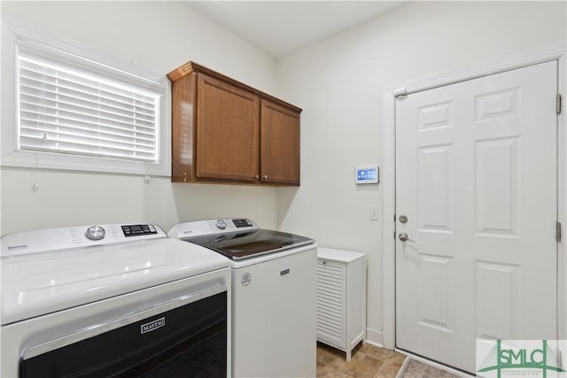 laundry room with cabinets and washer and dryer