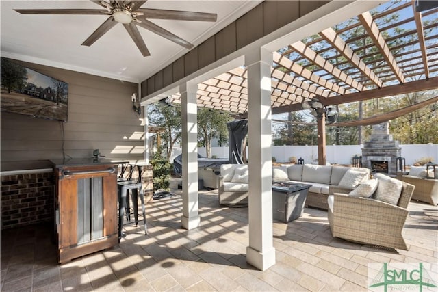 view of patio with a pergola, an outdoor living space with a fireplace, and a bar