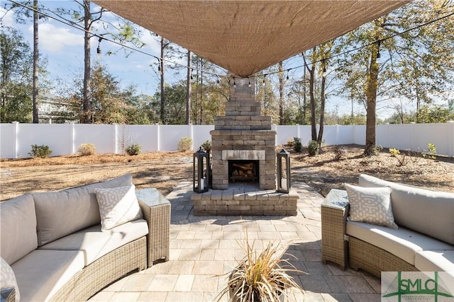 view of patio / terrace with an outdoor living space with a fireplace